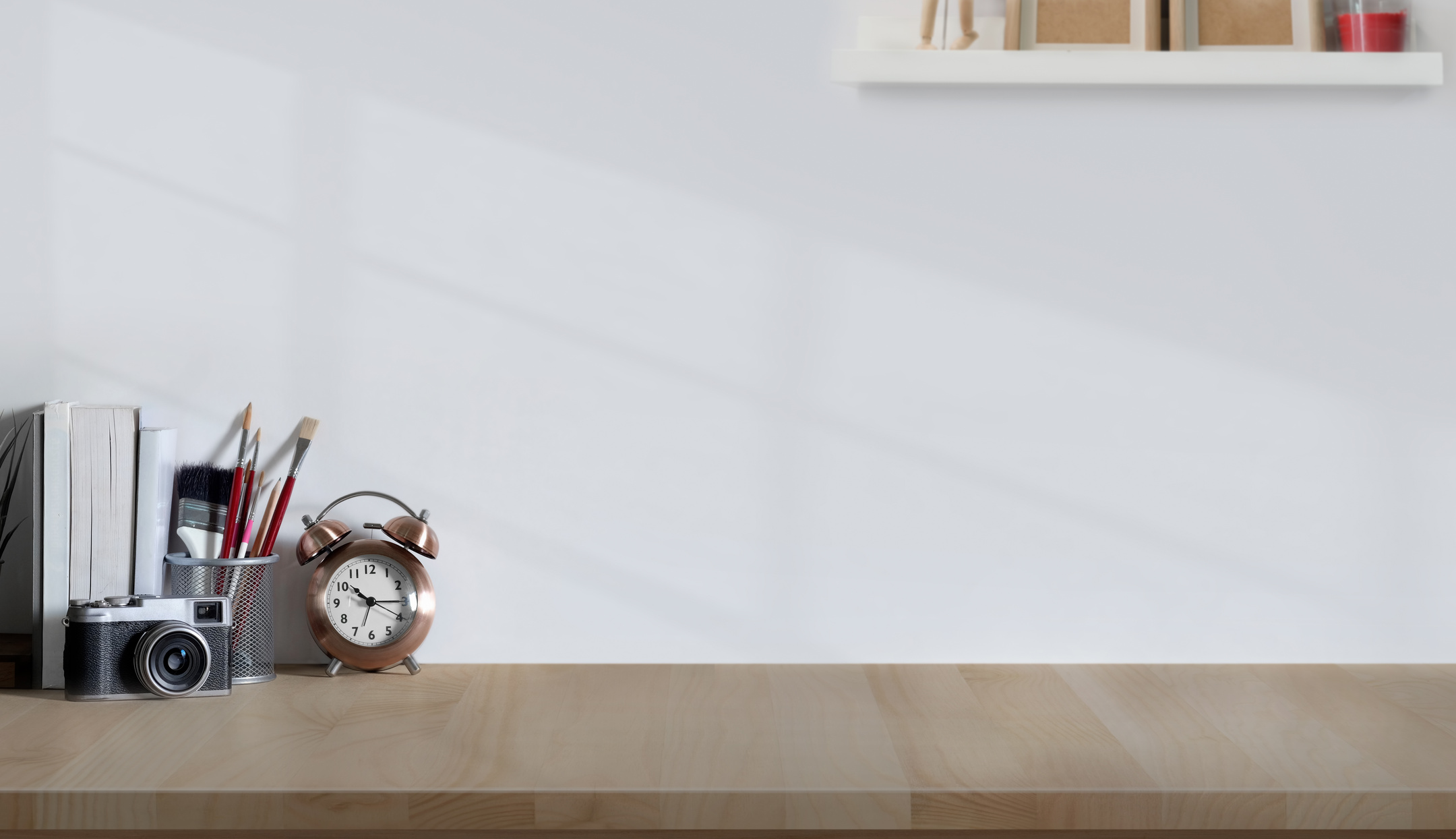 Alarm Clock And Analog Camera On Wooden Desk